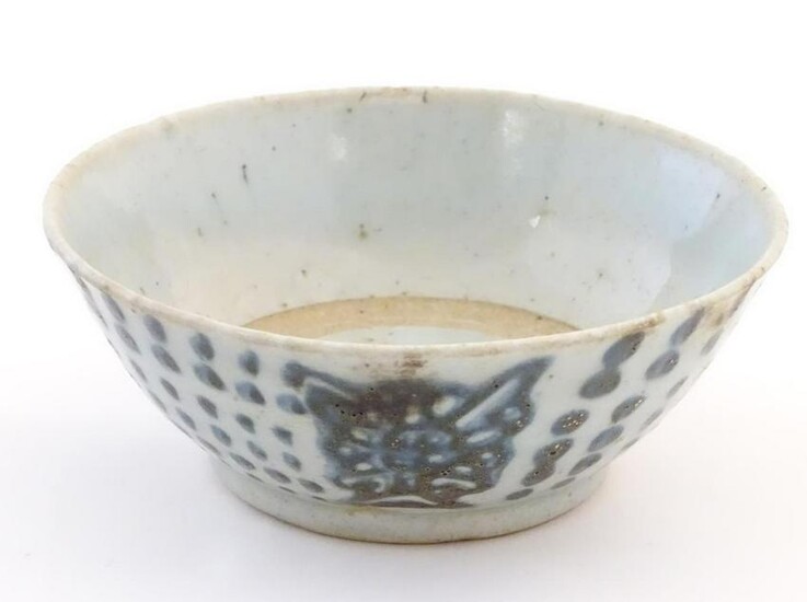 An Oriental earthenware bowl with brushwork detail.