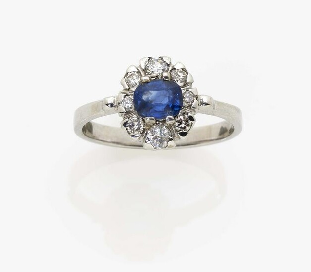 An entourage ring with a ''Kashmir'' sapphire and