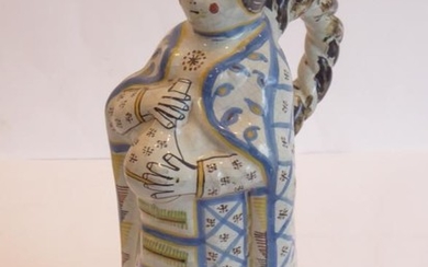 An unusual French faience jug modelled as a standing...