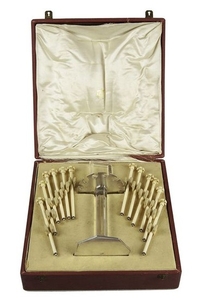 Art Deco Champagne Swizzle Sticks Stand, Silver and gold, rock crystal. 12 bone swizzle sticks of one design with cabochon moonstone finials set in silver Height: 22 cm Diameter of base: 8.5 cm Signed Cartier and numbered S 5 French silver hallmarks...