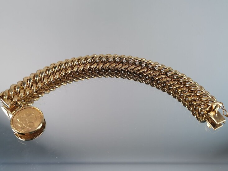 Bracelet en or jaune articulé orné d'une pièce de 20F or. 41,88 grs