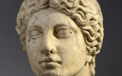 Female head in marble with hair banded with a headband.