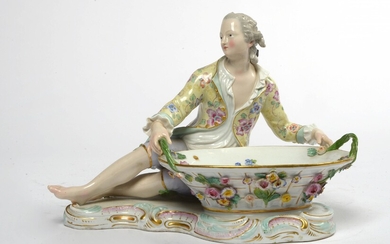 Grande salière en porcelaine polychrome de Meissen représentant un "Gentilhomme tenant un panier". Marque en...