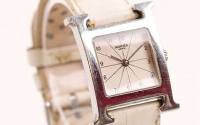 HERMÈS Paris, "Heure H" watch in steel, white dial D: 21 mm, Arabic numerals, quartz movement. Signed and numbered (as usual)