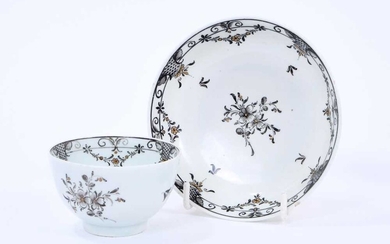 Lowestoft tea bowl and saucer, pencilled in black with flower sprays and formal borders of diaper and flower garlands, picked out in gold, saucer 11.2cm diameter