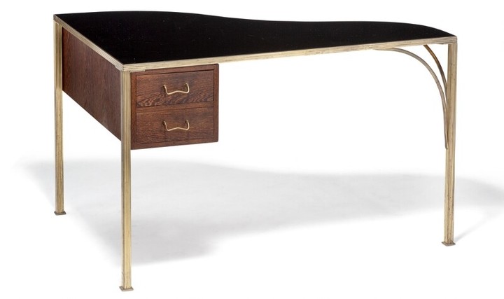 Lysberg, Hansen & Therp: Small desk/table with profiled brass frame with curvy stretchers. “Grand piano” shaped top with black glass. Wengé drawer section.