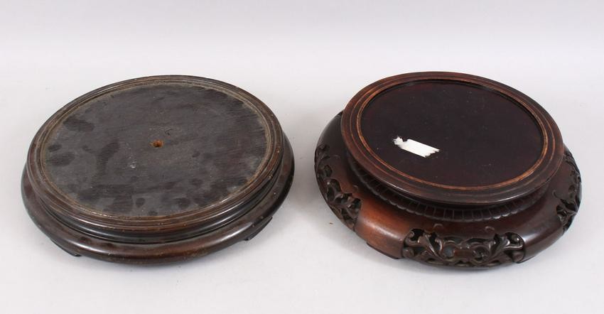 TWO CHINESE CARVED HARDWOOD CIRCULAR STANDS, for vases