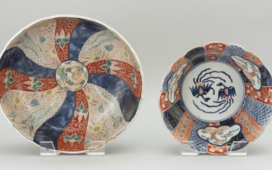 TWO JAPANESE IMARI PORCELAIN BOWLS 1) With shaped rim, and decoration of a pinwheel design about a dragon center. Diameter 12.25". 2...
