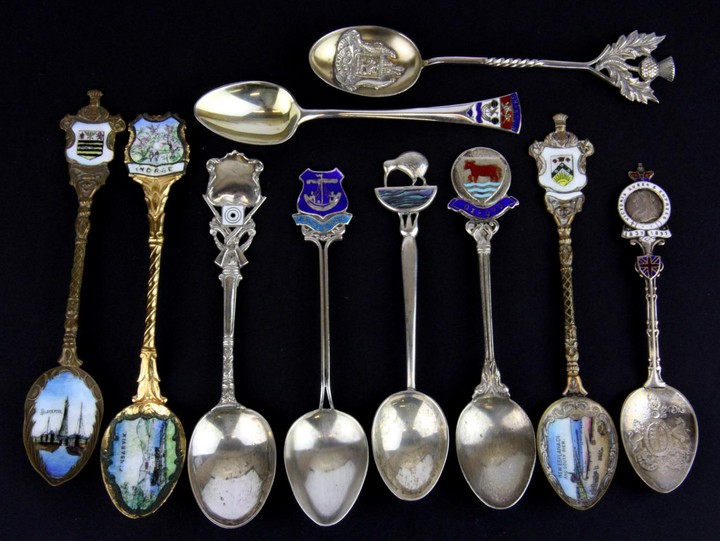Ten mixed silver and silver gilt tea spoons some with enamel decoration.