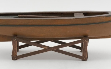 WOODEN MODEL OF A SKIFF With green painted stripes. Length 11.5". Includes one oar.