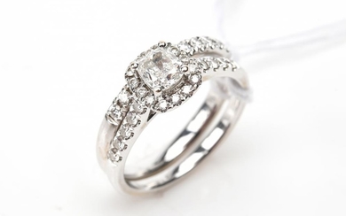 A CUSHION CUT DIAMOND RING OF 0.51CTS WITH DIAMOND SET SHOULDERS AND WEDDER IN 18CT WHITE GOLD