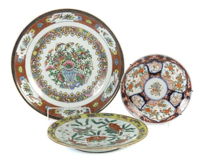 3 wall plates China, 19th/20th century, porcelain, various decorations: 1x cantonal painting with flower bouquet and butterflies, red brush mark; 1x depiction of ornamental fish between pond plants as well as 1x Imari painting, indistinct press mark...
