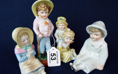 Four Continental porcelain children figurines.