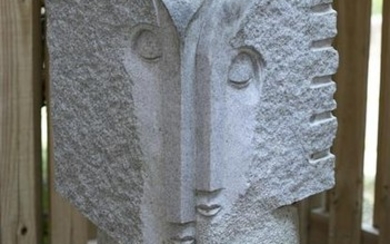 Large double-face carved stone sculpture.