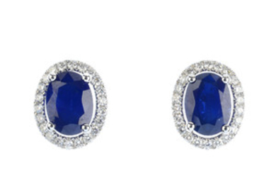 A pair of sapphire and diamond cluster earrings. View more details