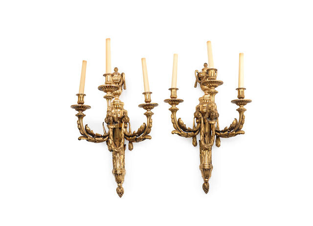 A pair of large gilt bronze three light wall appliques