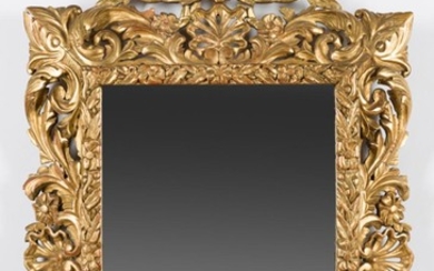 A 19TH CENTURY FLORENTINE GILTWOOD MIRROR, WITH A CARVED SHELL AND FOLIATE FRAME 90CM H X 59CM W