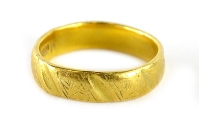 A 22ct gold wedding band, of polished and etched...