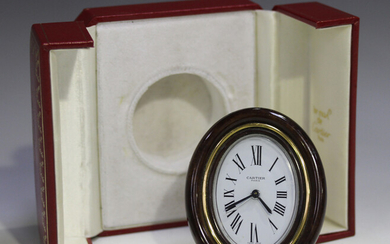 A Cartier gilt brass and brown lacquer bedside alarm clock, Ref. 7509, with manual wind movement, th