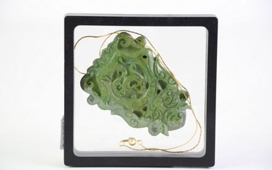 A Carved Green Stone Large Pendant