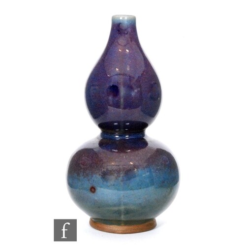 A Chinese flambe glaze gourd vase, the magenta glaze extendi...
