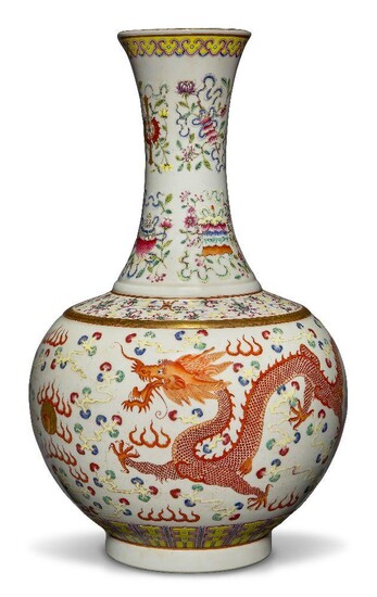 A Chinese porcelain famille rose 'dragon and phoenix' vase, Republic period, decorated to the body with a dragon and a large phoenix among polychrome clouds above lappets around the foot, the neck decorated with the Eight Buddhist Emblems...