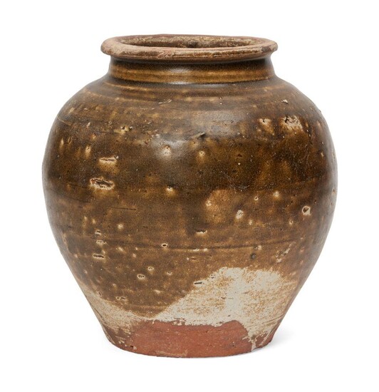 A Chinese pottery ash-glazed jar, Tang dynasty, the dark green...