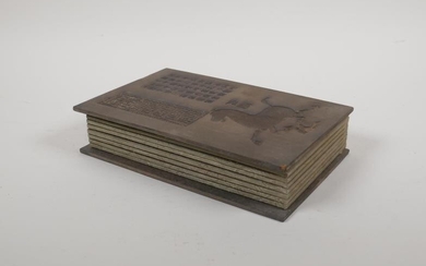 A Chinese silk and hardwood bound book containing white...