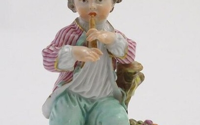 A Continental porcelain figure of a boy playing a