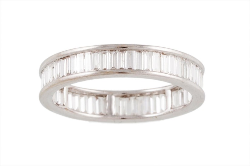 A FULL BANDED DIAMOND ETERNITY RING, set with baguette cut d...