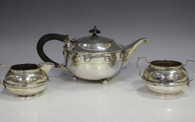 A George IV silver teapot of squat circular form, decorated in relief with circular cabochons, raise