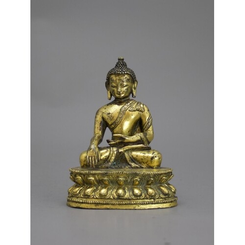 A Gilt Bronze seated Buddha, 16th /17th centuryH: 9.6cm A G...