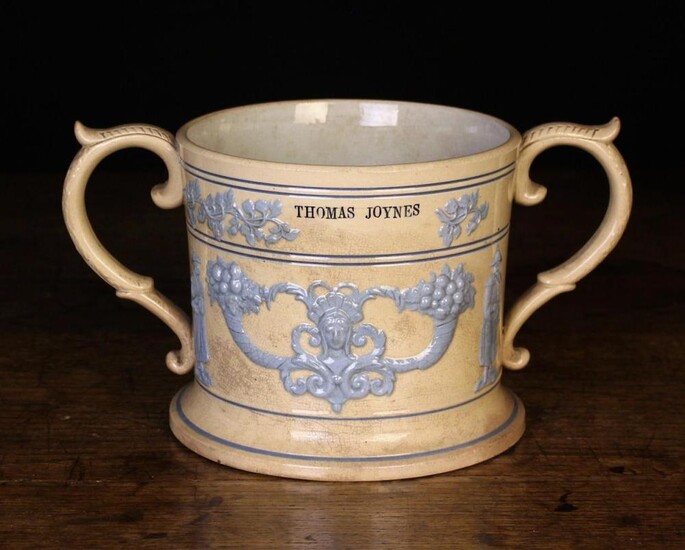 A Large 19th Century Loving Mug sprigged with pale blue glazed relief moulded decoration and impress