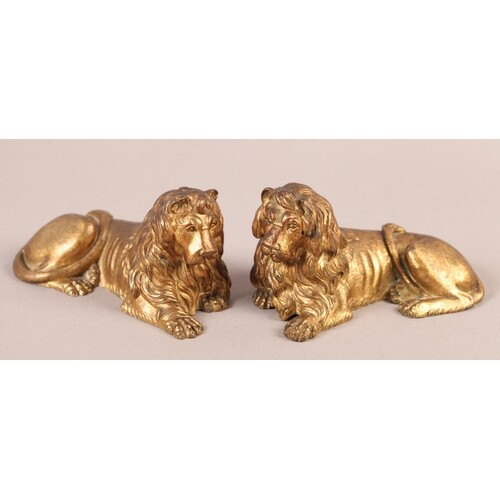 A PAIR OF 19TH CENTURY ORMOLU FIGURES OF RECUMBENT LIONS, re...