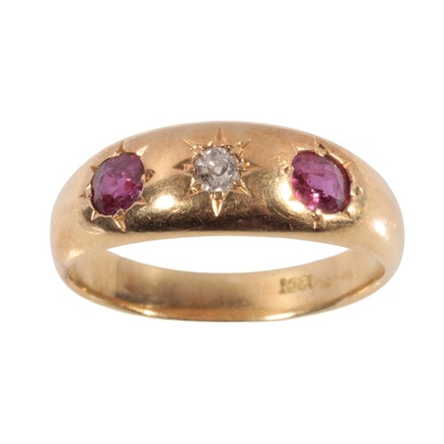 A RUBY AND DIAMOND GYPSY STYLE RING set with two oval-cut ru...