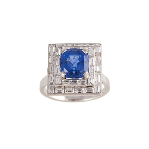 A SAPPHIRE AND DIAMOND PLAQUE RING, the oval sapphire to a t...