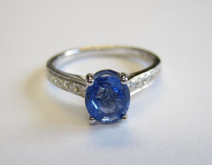 A Sapphire and Diamond Ring claw-set oval-cut sapphire, 1.24cts,...