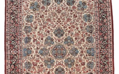 A Sarouk carpet, Persia. All over design of flowers and rosettes on an ivory field. C. 1950–1960. 304×211 cm.
