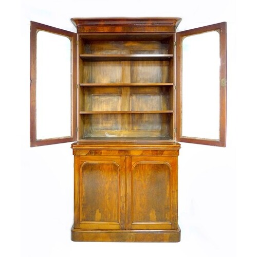 A Victorian mahogany and walnut veneered bookcase, twin glaz...