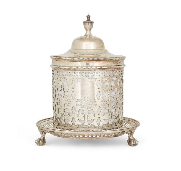 A Victorian silver mounted biscuit barrel, Sheffield, 1887, Henry Wilkinson & Co., the pierced stand raised on three claw and ball feet to pierced body with white ceramic liner, the domed lid designed with finial and beaded border, 16.5cm high