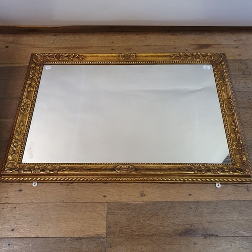 A carved wood and gesso wall mirror, 82 x 118 cm