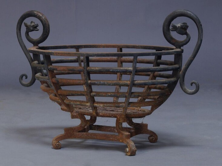 A cast iron fire basket, early 20th century, of oval...