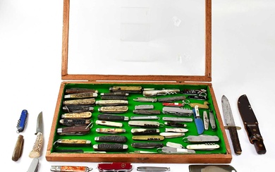 A collection of American Scout knives, Swiss Army knives, pen...