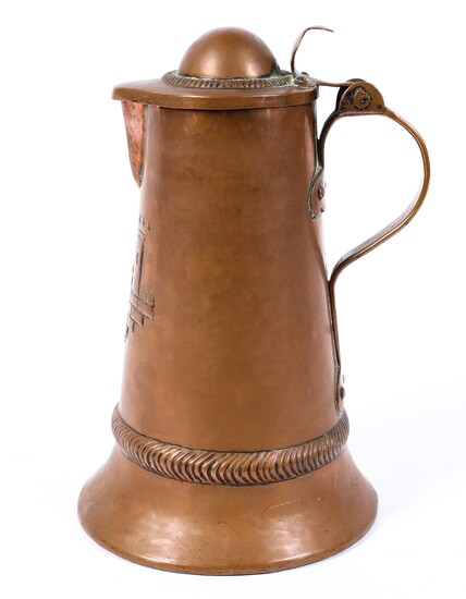 A copper lidded pitcher, with moulded decoration of a scene of a castle