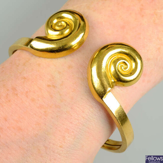 A cuff bangle with shell motif terminals, by Ilias Lalaounis.