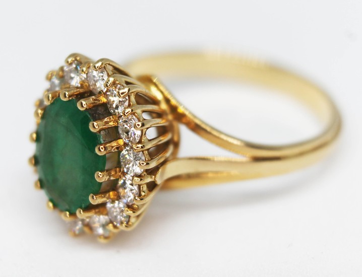 A diamond and emerald cluster ring, crafted in yellow metal ...