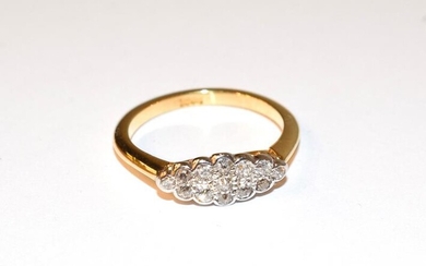 A diamond cluster ring, the old cut diamonds in white...