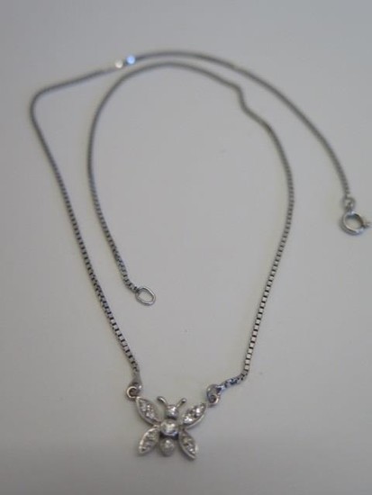 A diamond insect necklace in white metal, possibly white gol...