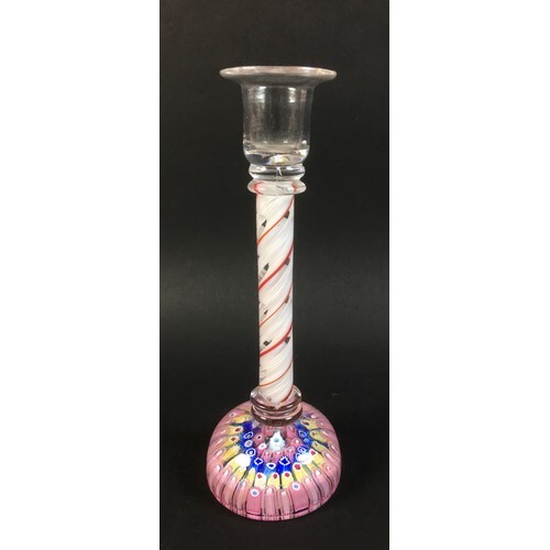 A glass candlestick with candy twist stem in white red and c...