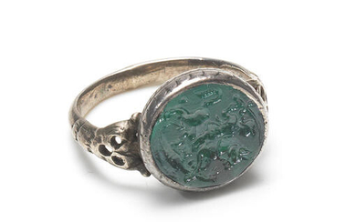 A green paste intaglio and silver ring, 19th century, or earlier